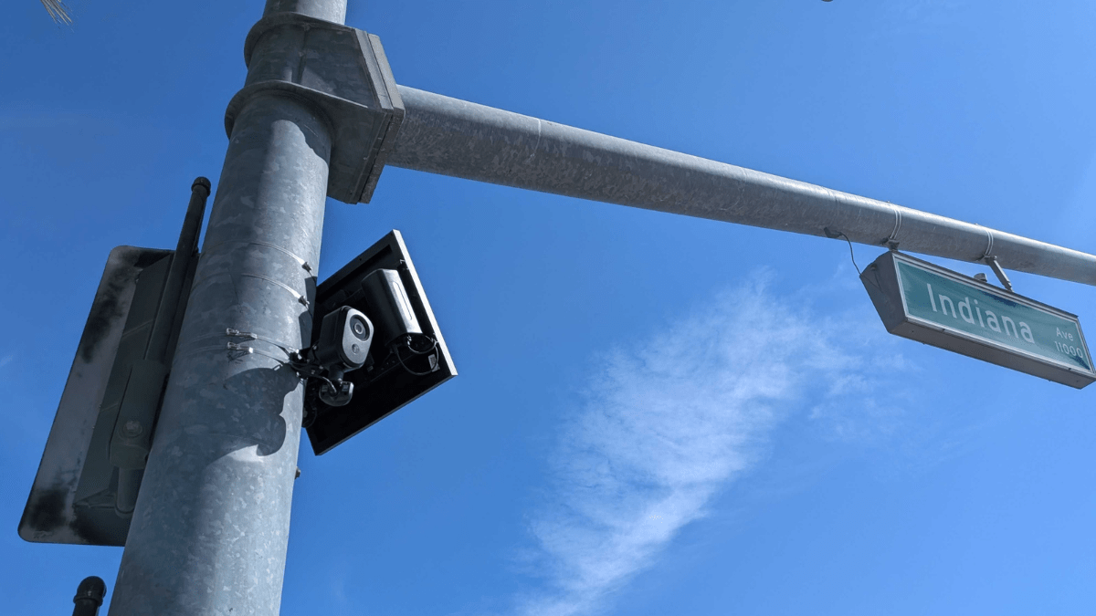 A Flock camera attached to a light pole.