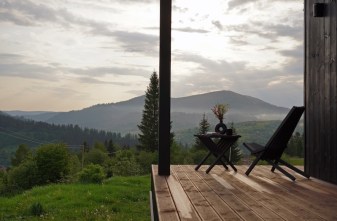 wooden outdoor furniture on terrace with mountain view in Ukraine