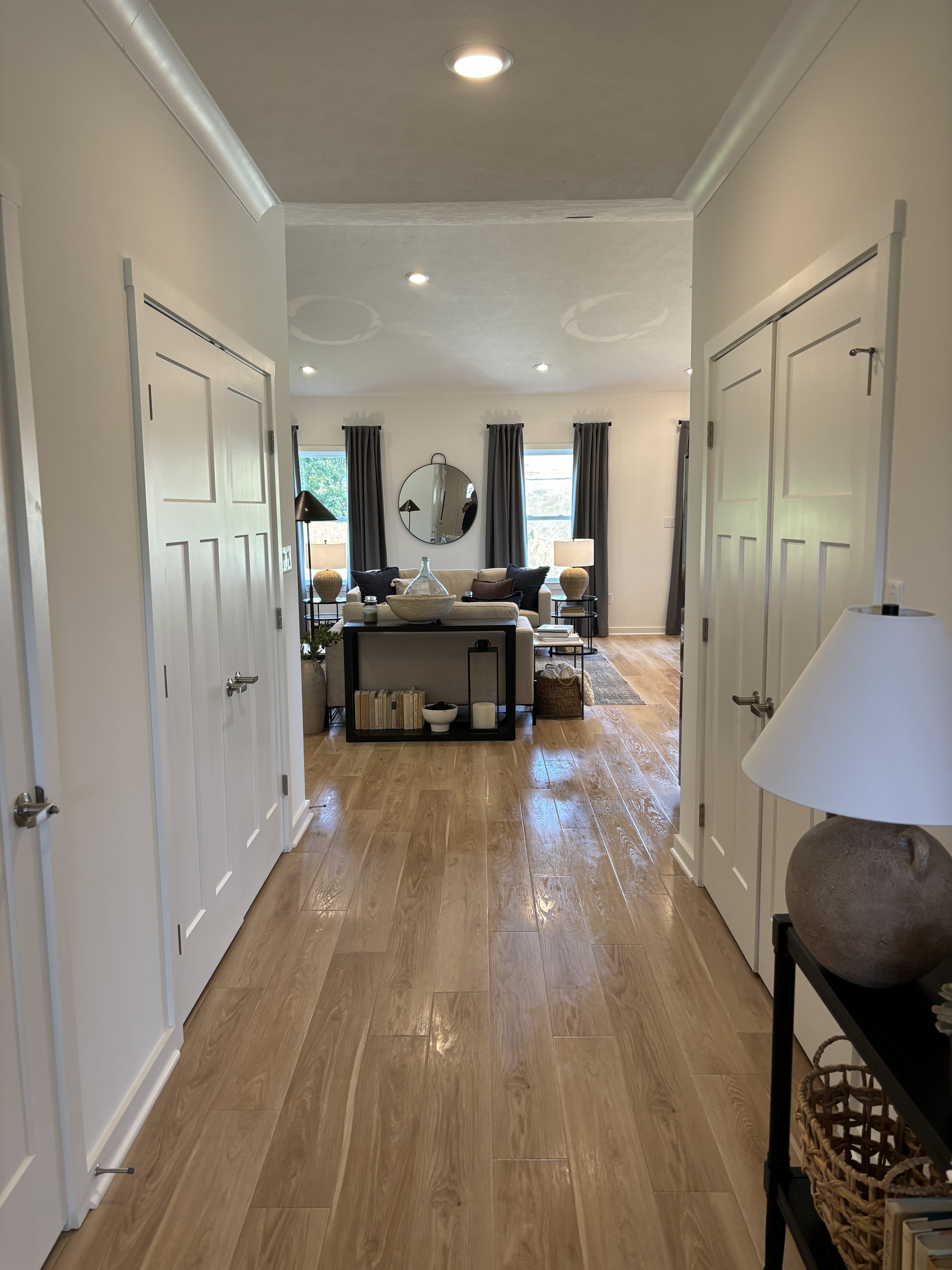An image of a hallway in a home with wooden floors