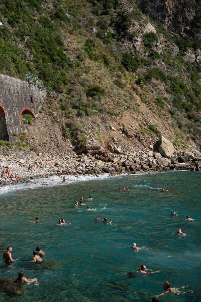 swimmers in the sea in cinque terre