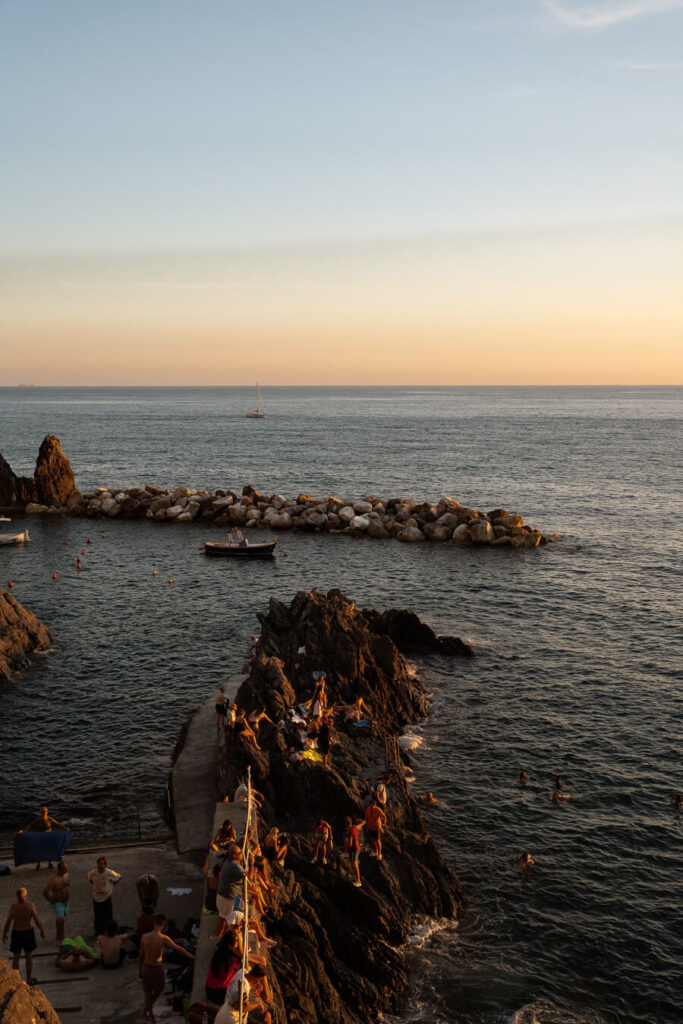 tourists watching sunset in cinque terre italy