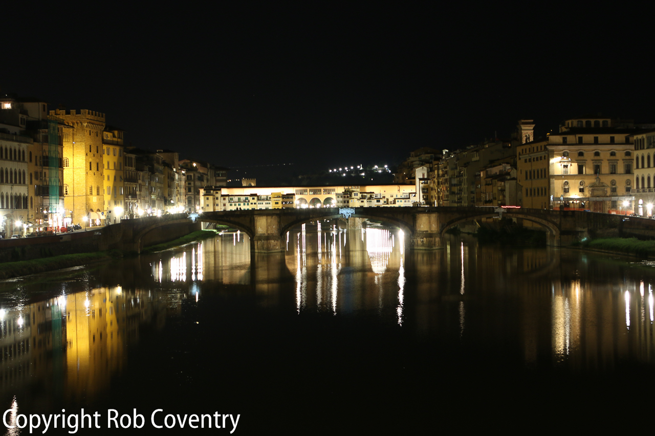 Looking down river to two bridges, the Ponte Santa Trinita and behind it, the Ponte Vecchio