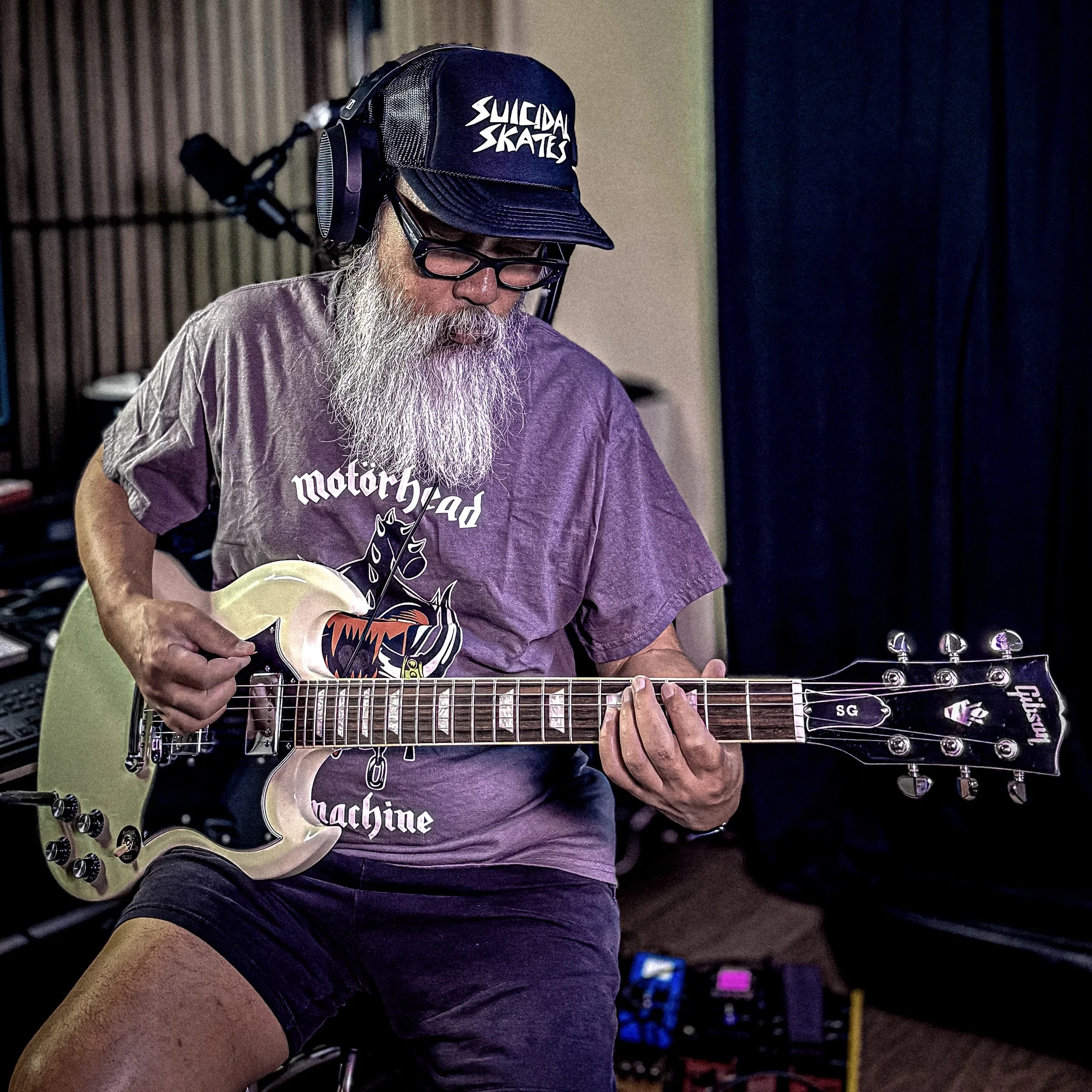 Robin Malau wearing Toy Machine's Geoff Rowley x Motorhead T-shirt while playing a white Gibson SG guitar