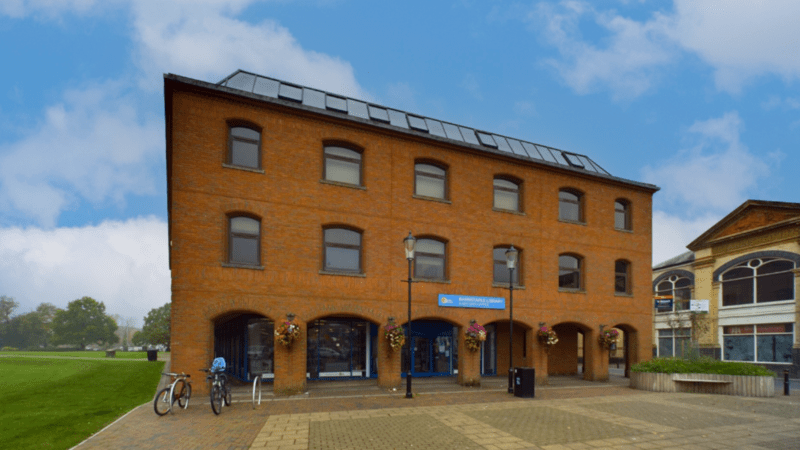 photo of a three-storey, red brick building