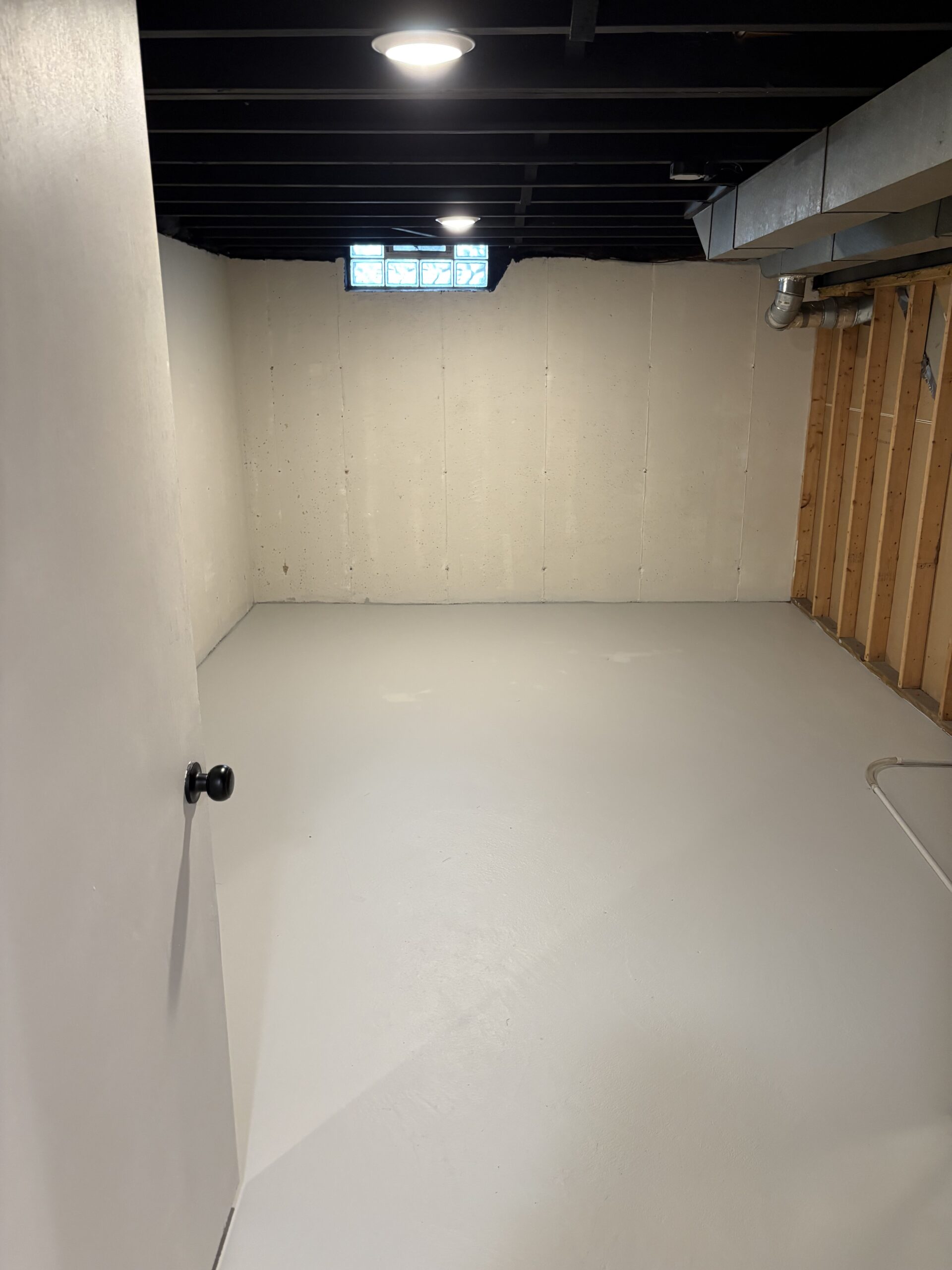 We painted the ceiling, floors and walls and tidied up the wiring in this basement storage space