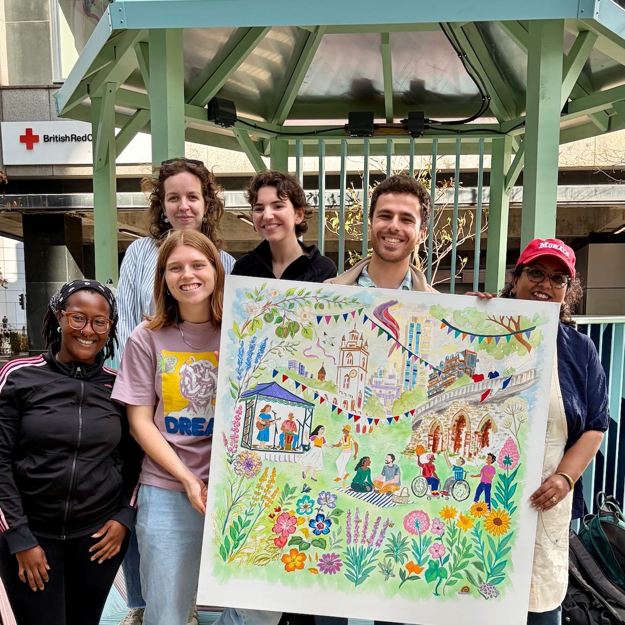 Participants and Roopa Basu holding the finished Culture Mile giant canvas in Moorgate