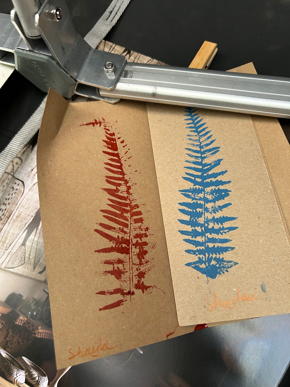 Two fern prints in red and blue on recycled card