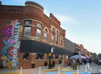 A large brick building with a colorful mural painted on the side.