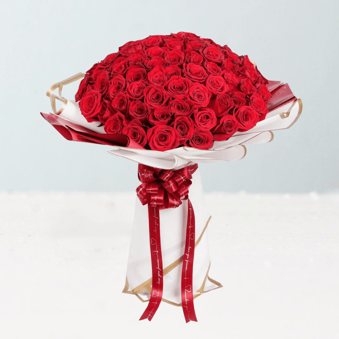 bouquet of 70 red roses wrapped in white and red paper with gold edges and printed ribbon