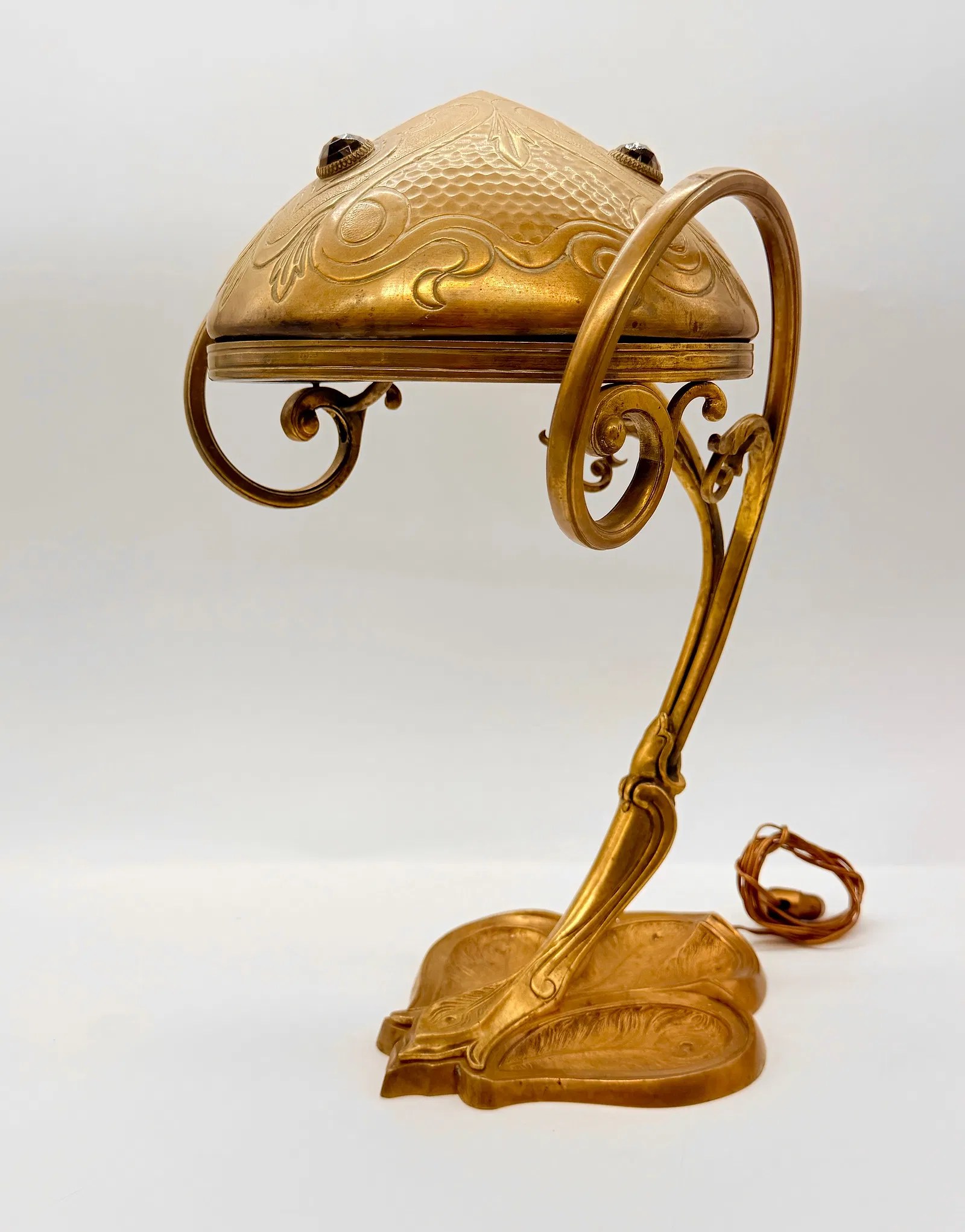 Austrian Art Nouveau gilt-brass desk lamp with a red glass cabochon, circa 1900