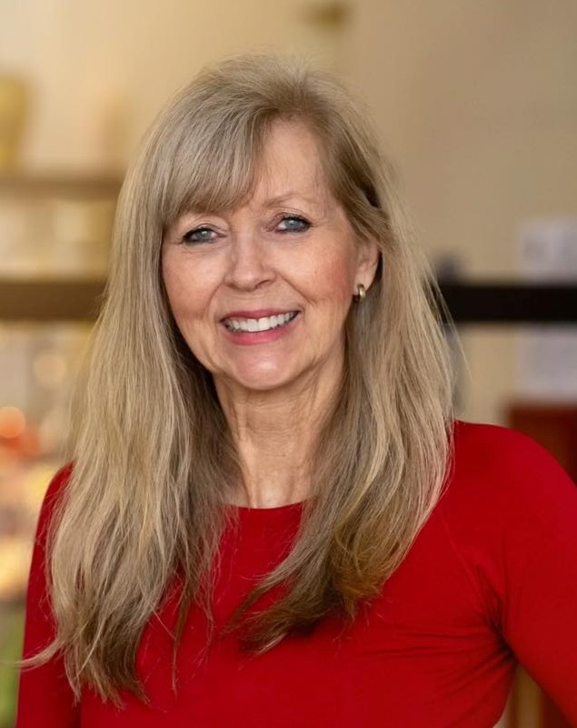 Heidi Larkin-Reed smiling at camera wearing red top, professional headshot