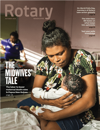 Midwife holding newborn infant, Rotary Magazine October 2024 cover story on maternal mortality in Papua New Guinea