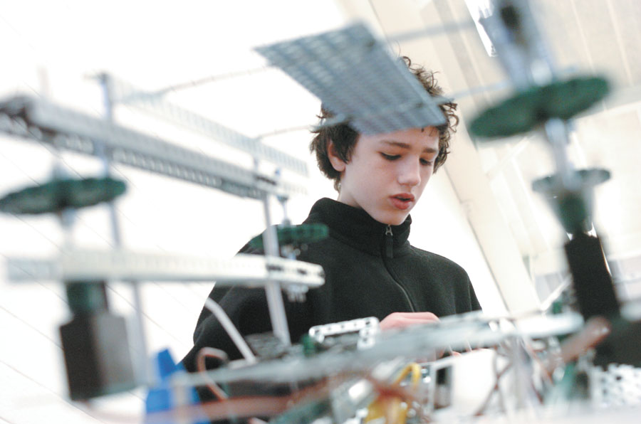 Kyle Shewmaker, a freshman and member of the Dunwoody High School robotics team, puts the finishing touches on his team’s creation during a DeKalb County competition at Cross Keys High School on Feb. 11.