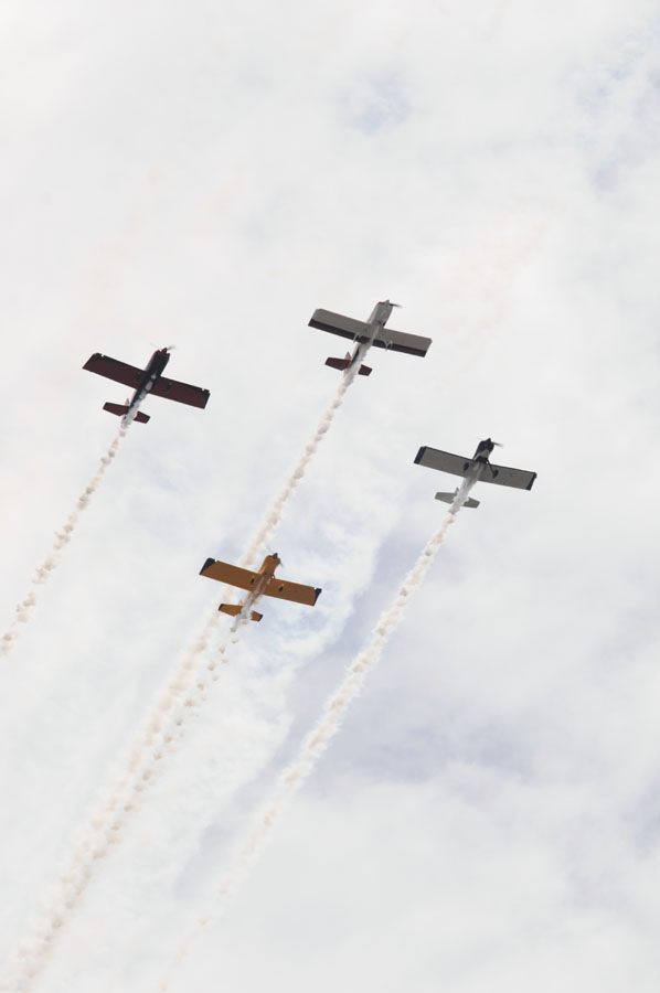 Planes fly in formation.