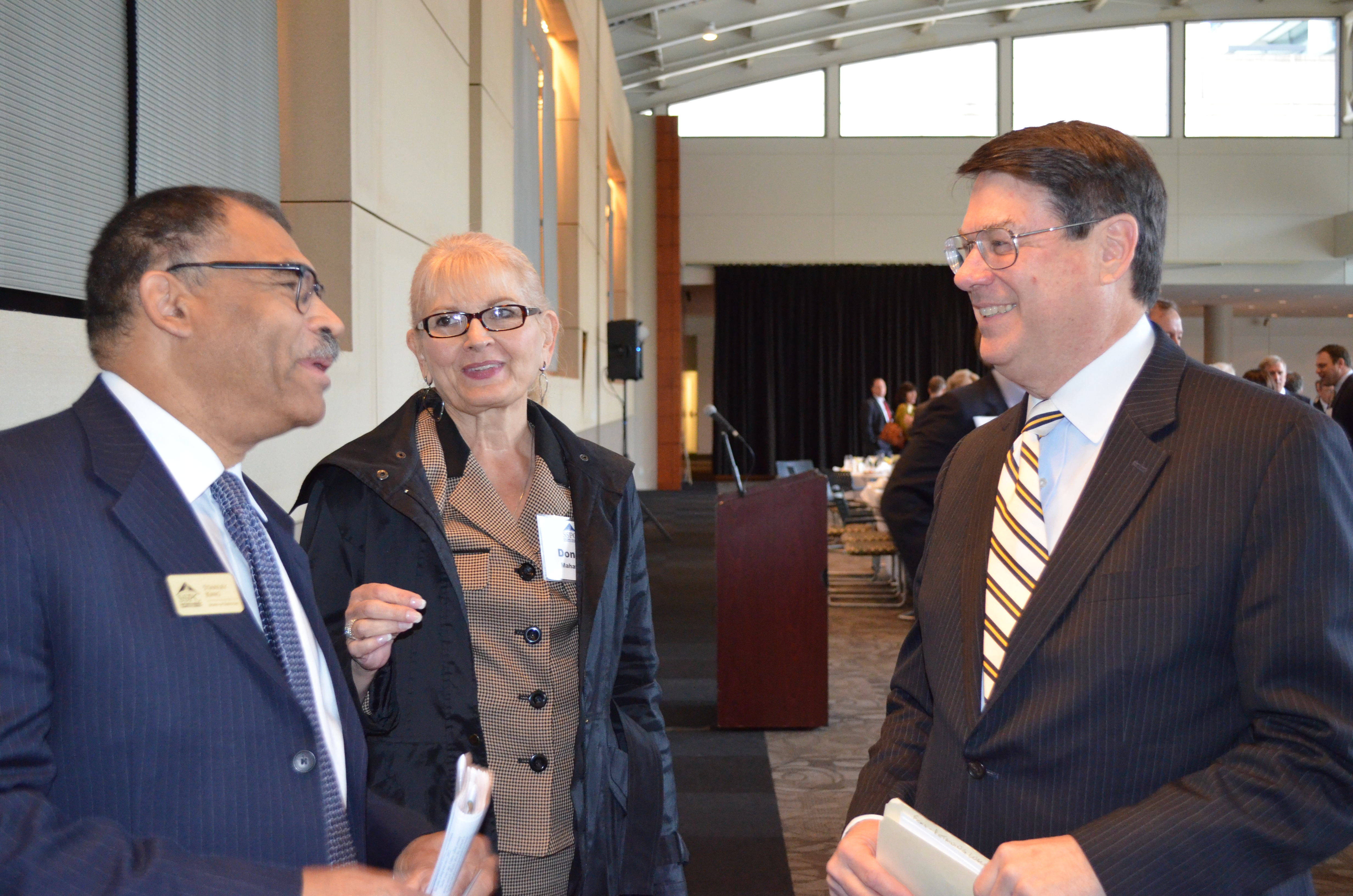 Sandy Springs Mayor Rusty Paul, right, chats with Perimeter Community Improvement District chief of external affairs Donna Mahaffey, center, and Sandy Springs/Perimeter Chamber board member Stanley King after Paul's first "State of the City" speech on 2.25.14 at The Retreat at Perimeter Summit.