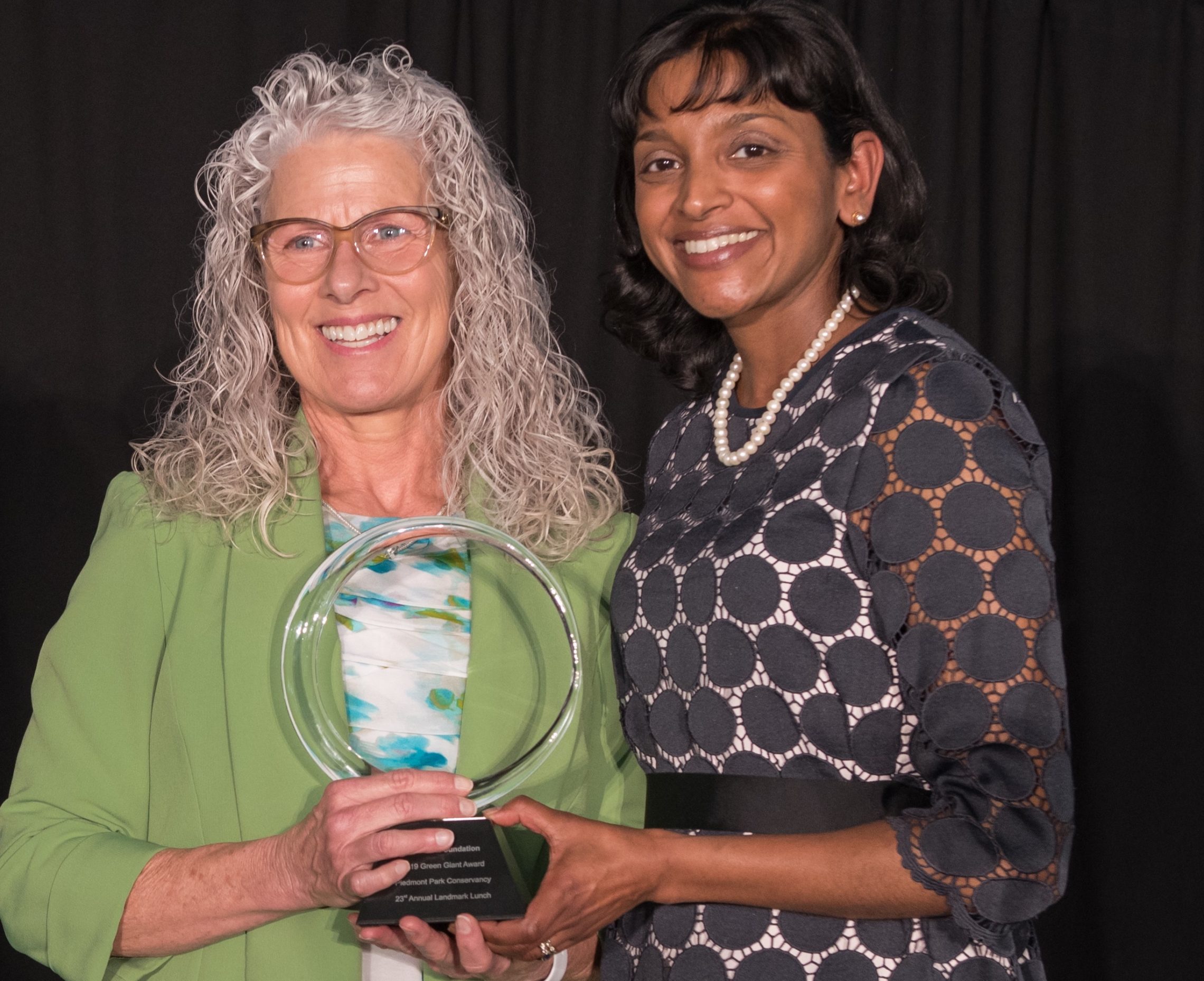 Arthur M. Blank Foundation's Suganthi Simon (right) presents the Green Giant Award to The UPS Foundation's Tamara Barker (left). (Photo by Rick Moll)