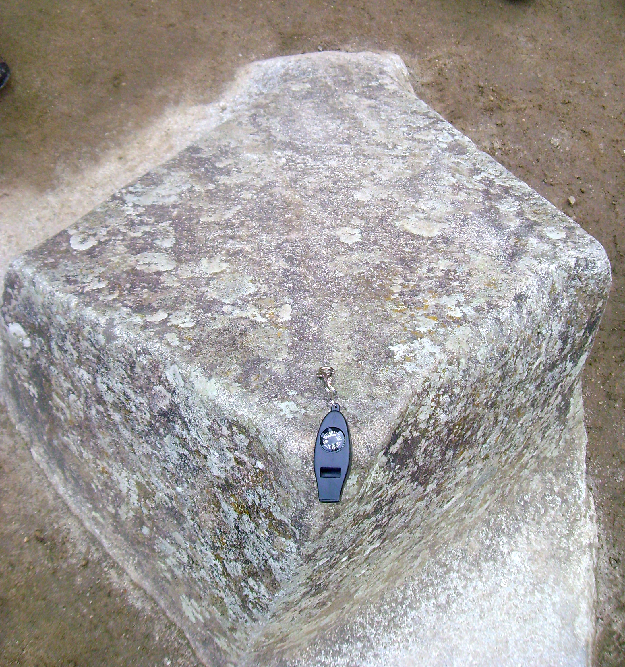 A compas carved from the mountain pointing directly North,South,East, and West.