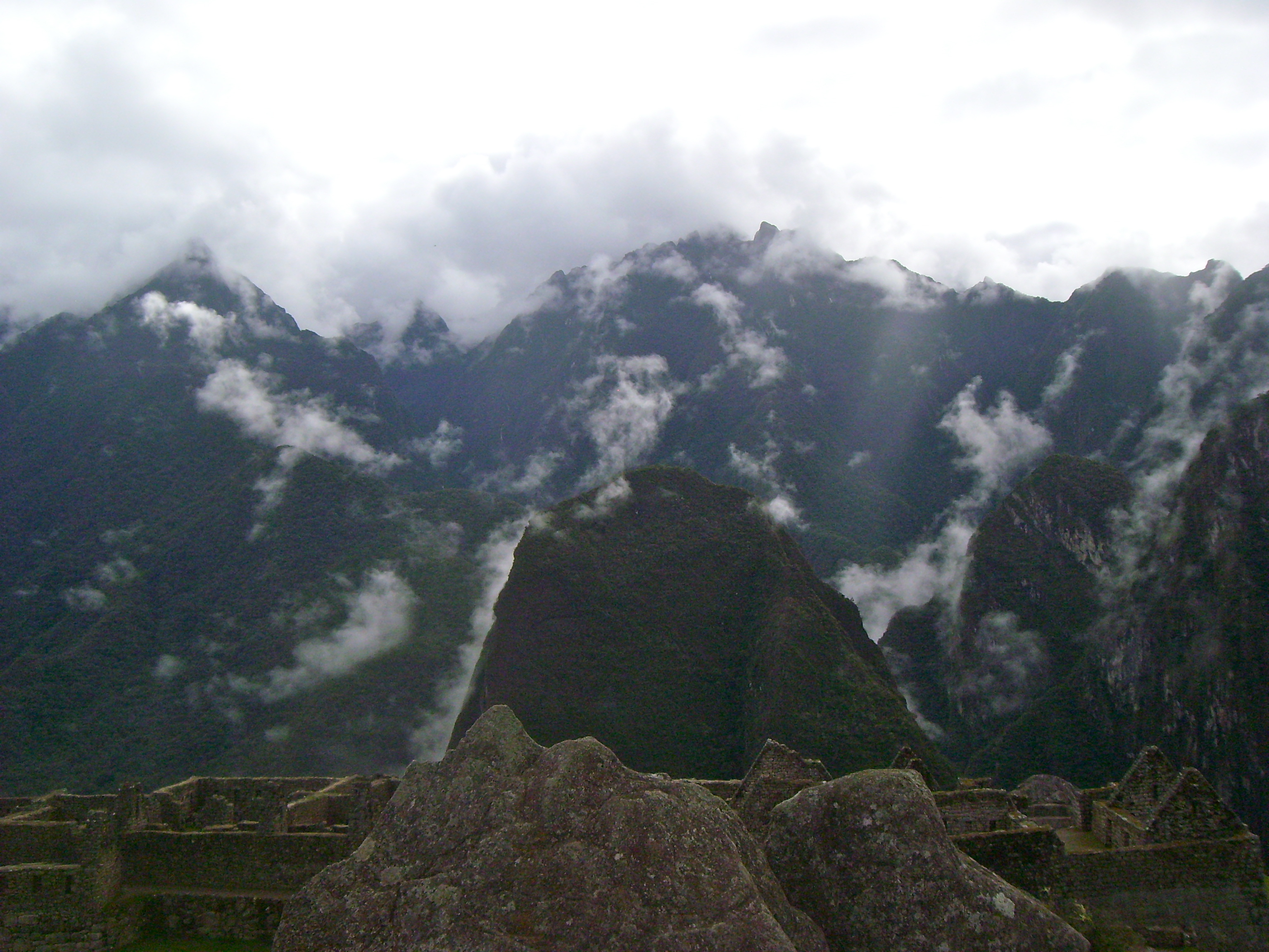 A rock carved to resembe the mountains in the background