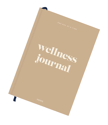 A soft cover wellness journal with a black fabric bookmark