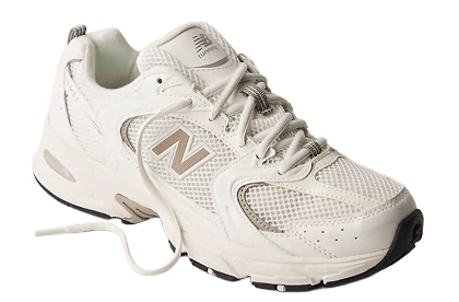 A white and gold New Balance shoe