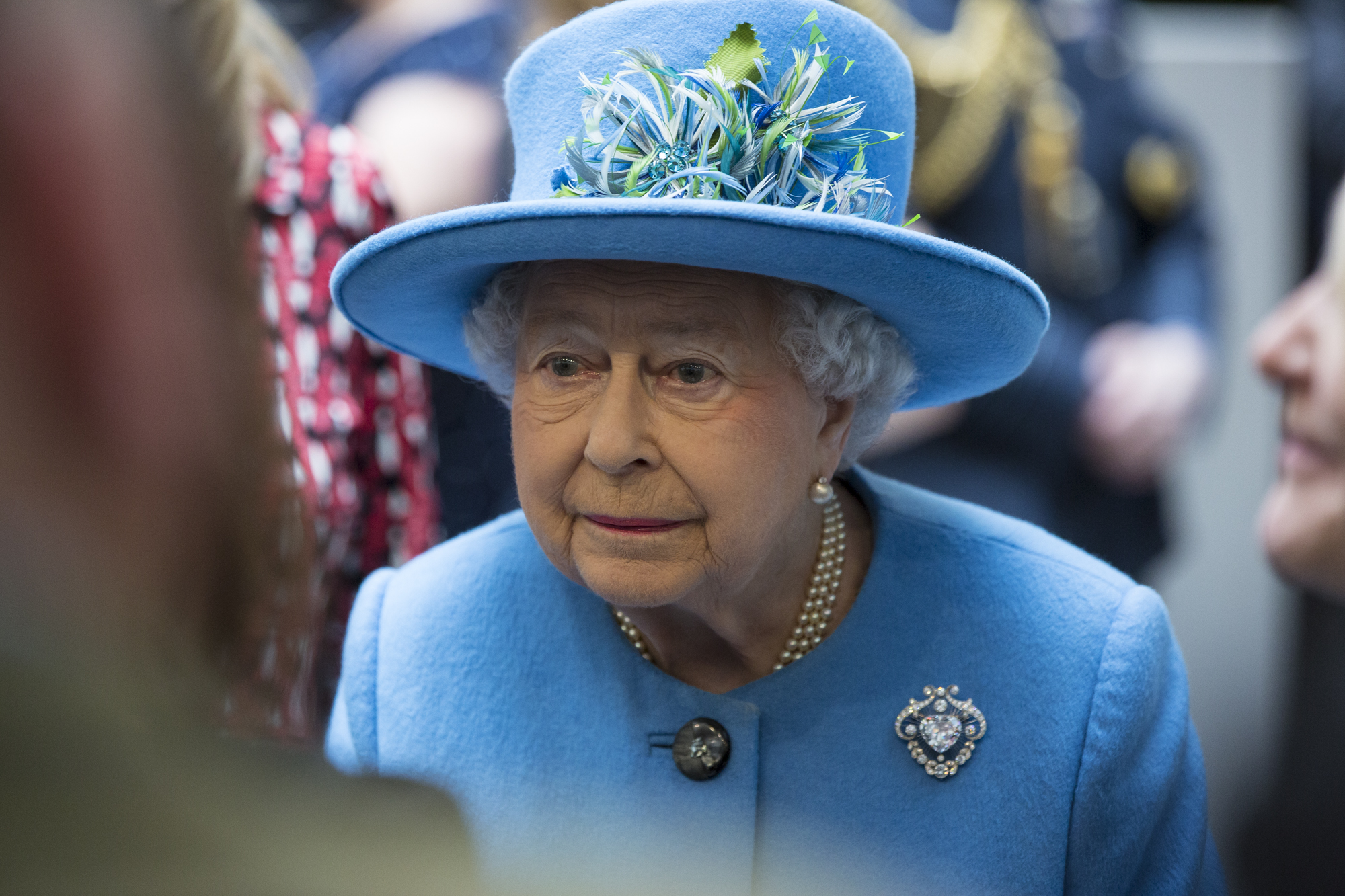 Queen Elizabeth II in a blue hat and coat during a 2015 visit.