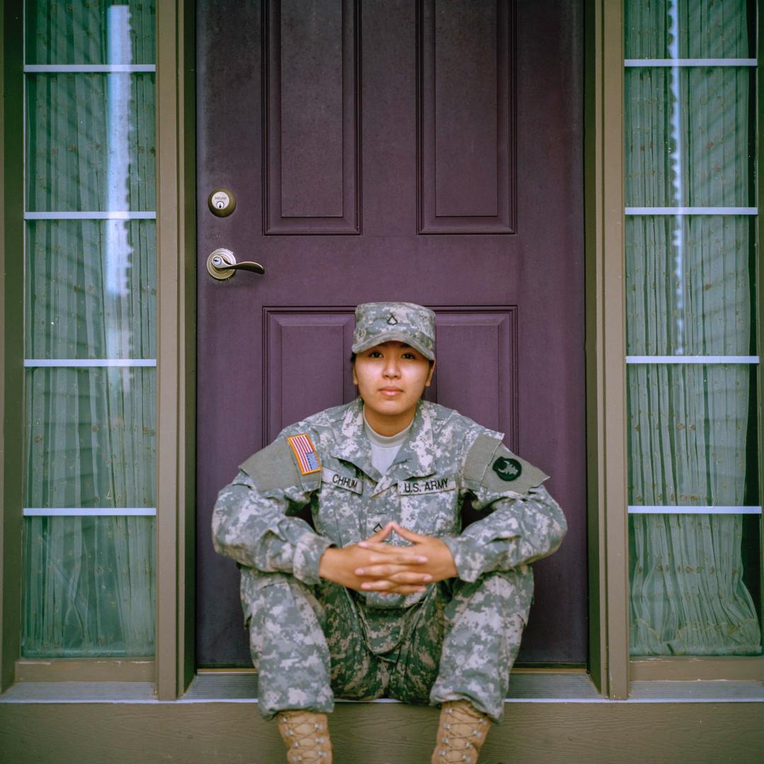 Army Woman Army woman sitting on step in front of a door