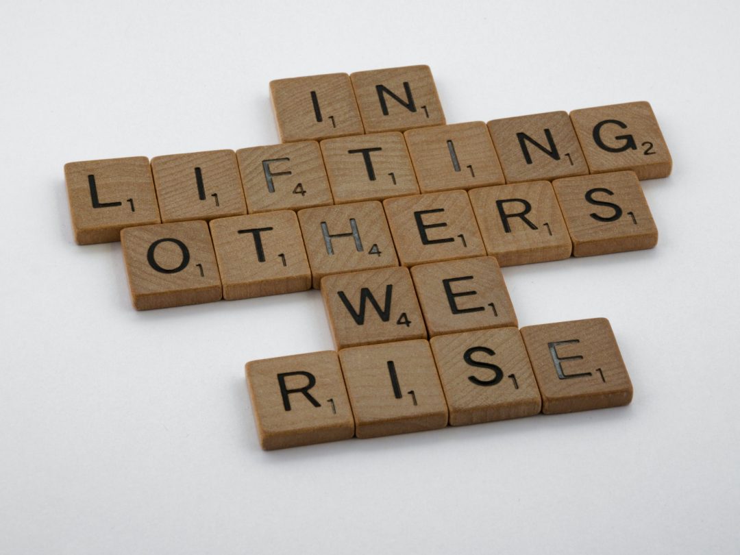 In lifting Others We Rise Navy Blue Angels in the air