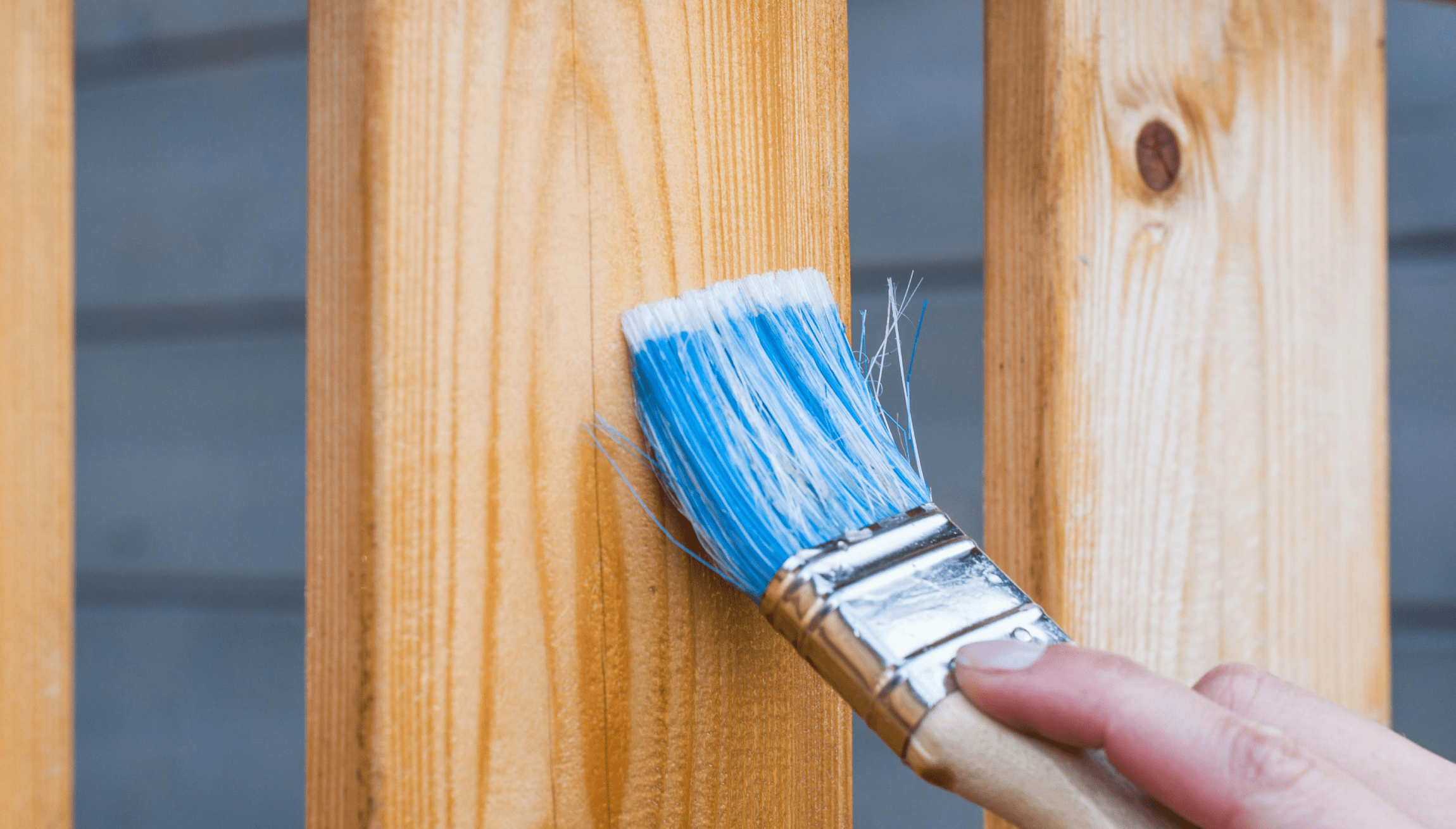 Handyman in New Jersey home priming deck panels.