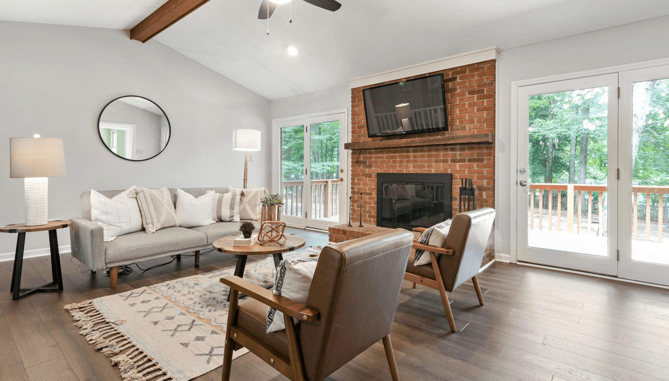 Living room remodeling and renovation in NJ home completed with glass doors leading to a wooden deck.