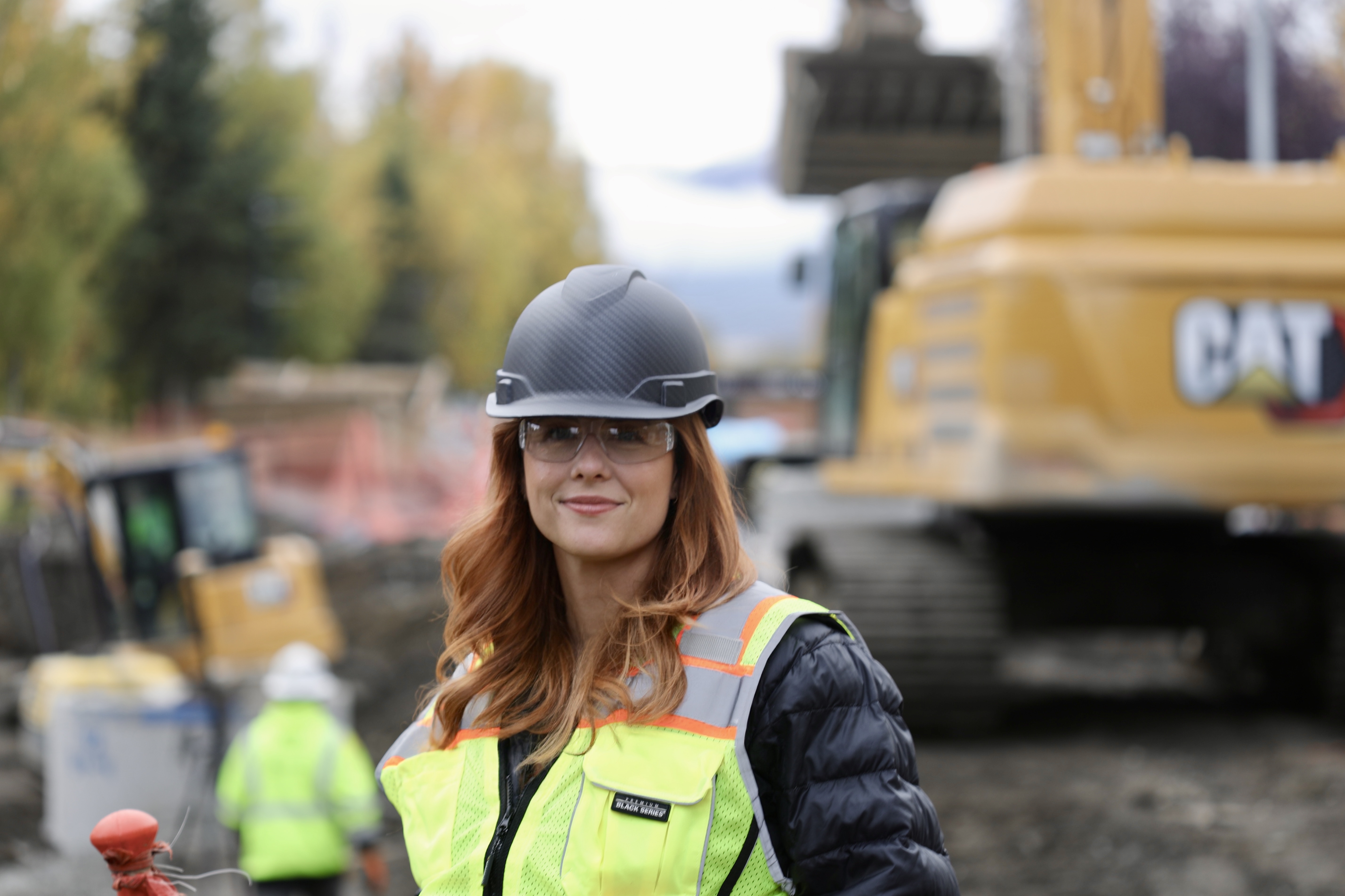 Ruby Jones wearing a hard hat and safety vest at a construction site