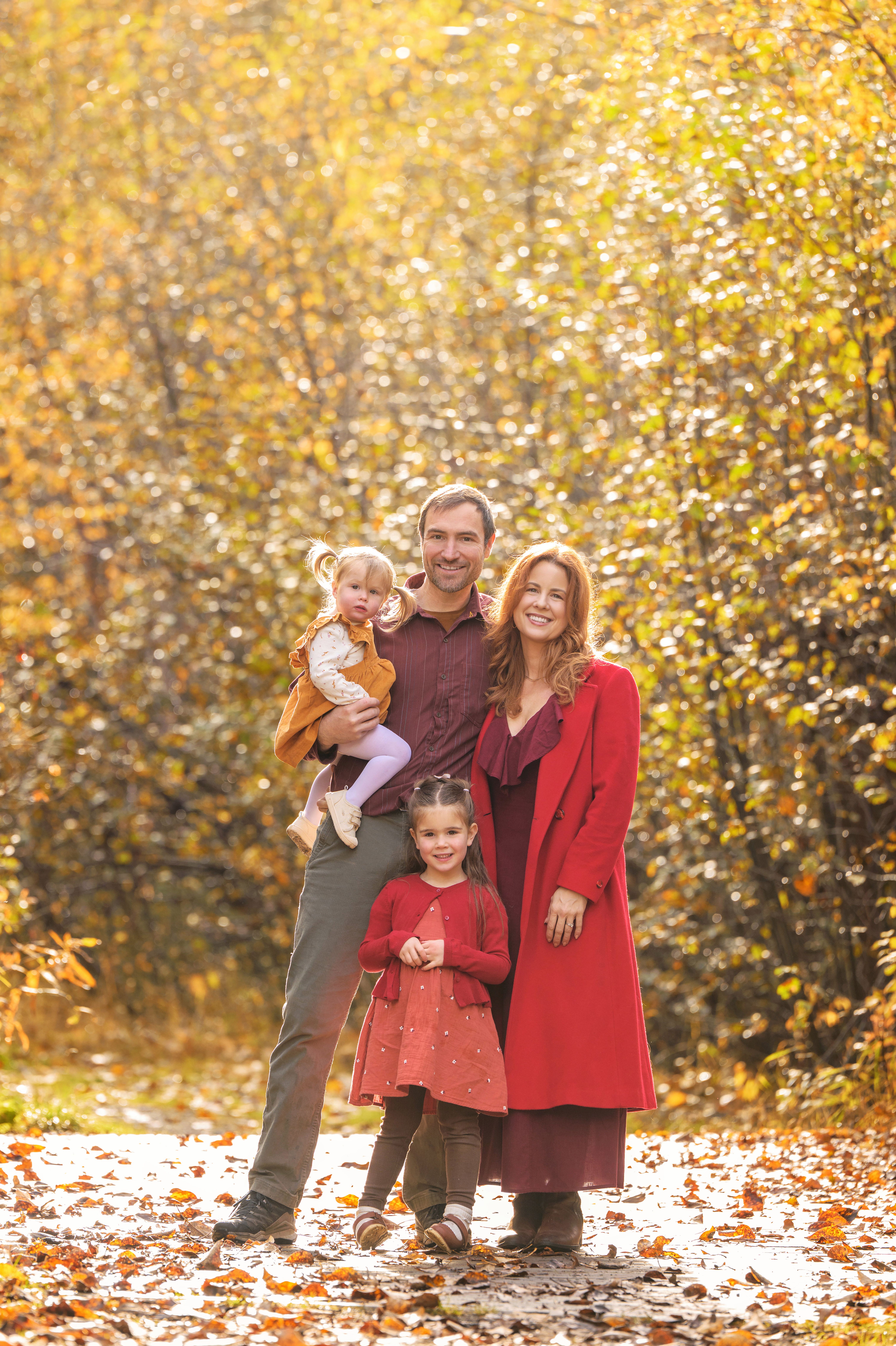 Ruby Jones with her family in a birch forest during fall