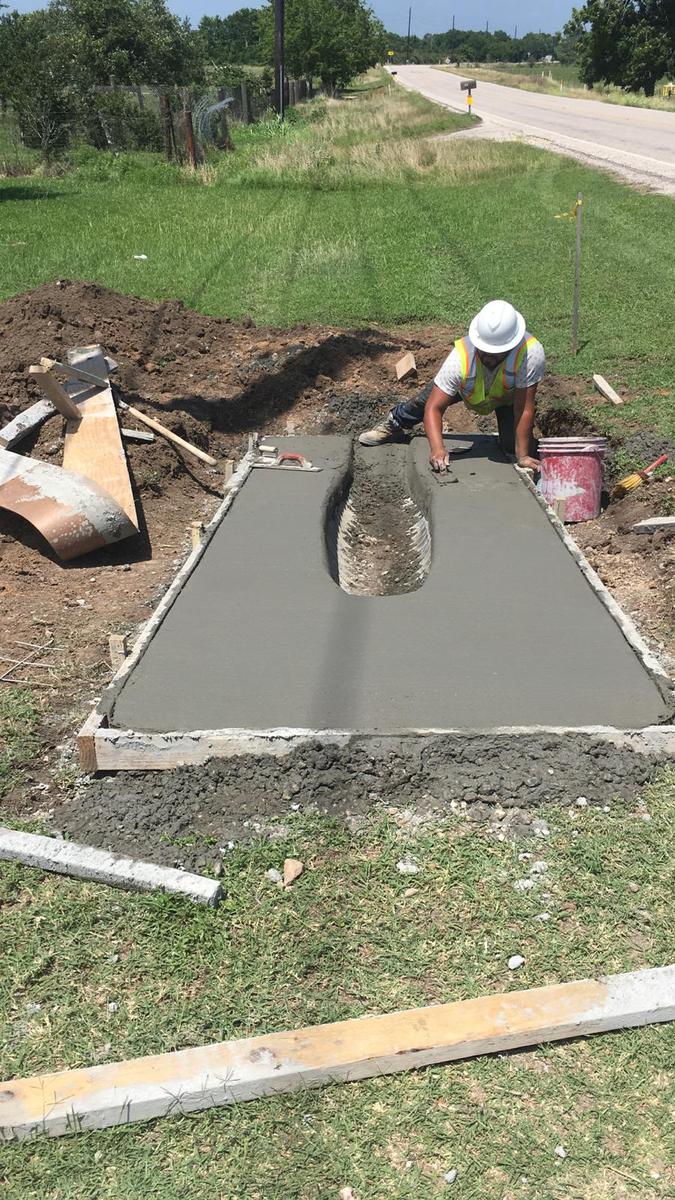 Construction worker from Rucoba & Maya finalizing the installation of a storm pipe, emphasizing precision and expertise.