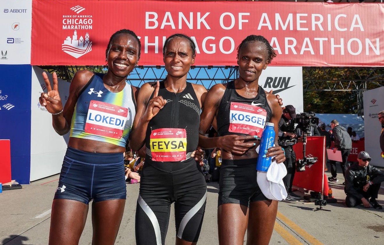 Sharon Lokedi, Hawi Feysa and Brigid Kosgei stand together after the 2026 Chicago Marathon.