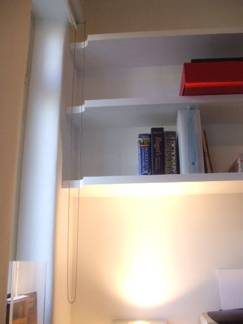 Shelves with cutout for blind pull