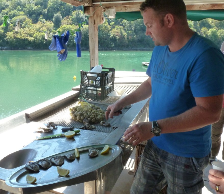 Drago prepares oysters from the clear water of the Lim Fjord