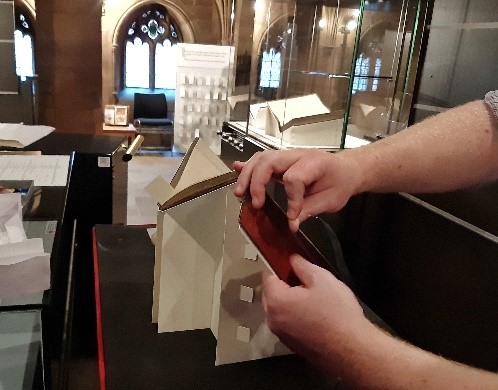 Strapping the book on a machine made cradle