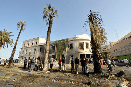People stand near a Libyan Foreign Ministry building in Benghazi after an explosion in Benghazi September 11, 2013. REUTERS/Esam Omran Al-Fetori