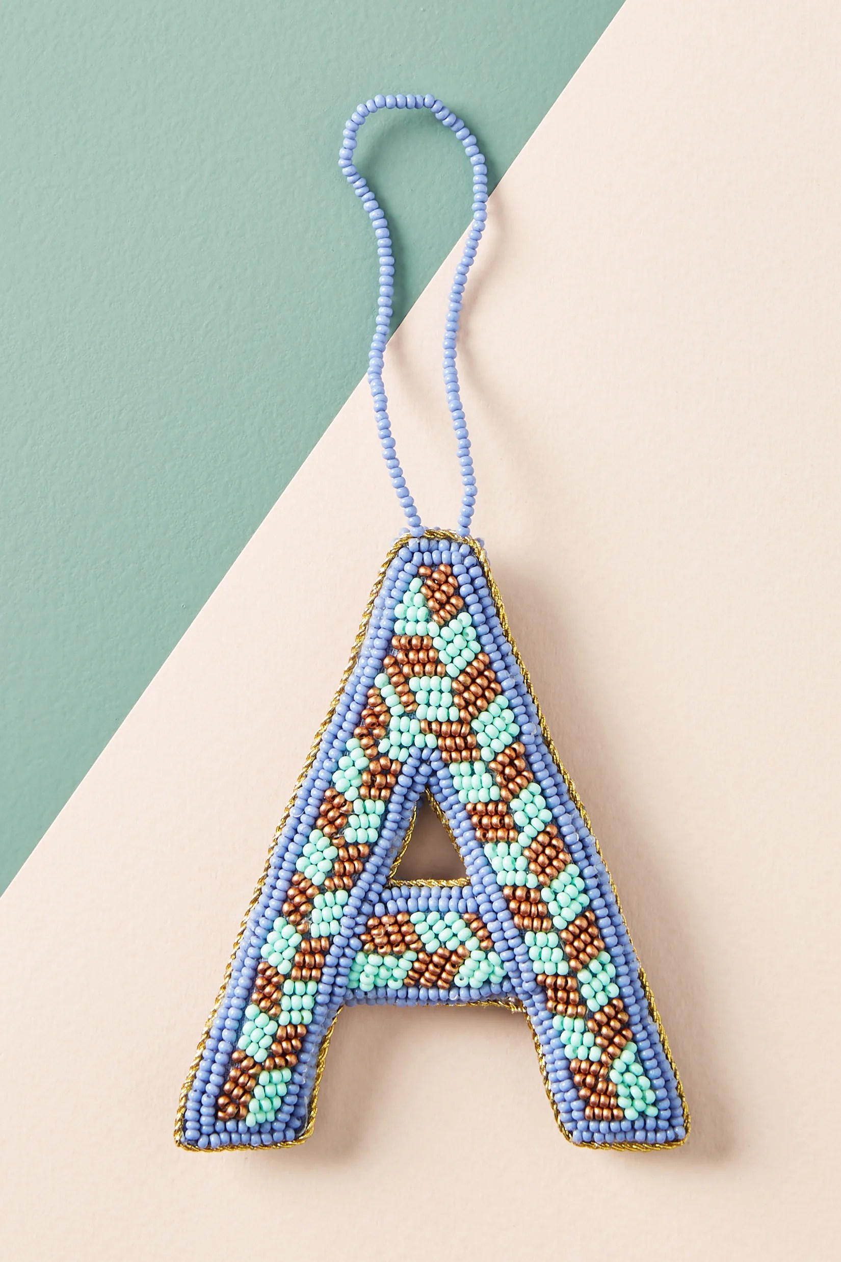 Start with an unfinished wood letter. Anthropologie Beaded Monogram Ornament