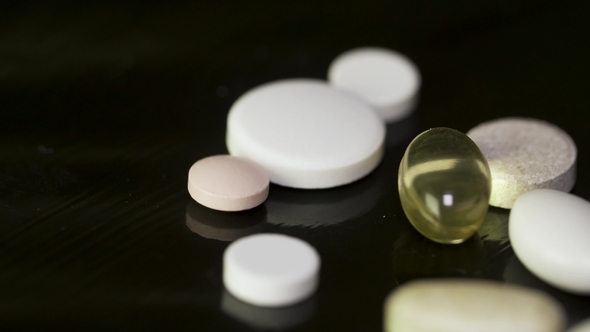 Multicolored pills and capsules on black background. is an authentic stock image by sciencerf. Various Colorful Pills On Black Background Pile Of Several Medicines On Black Background Colorful By Baldasaridstock