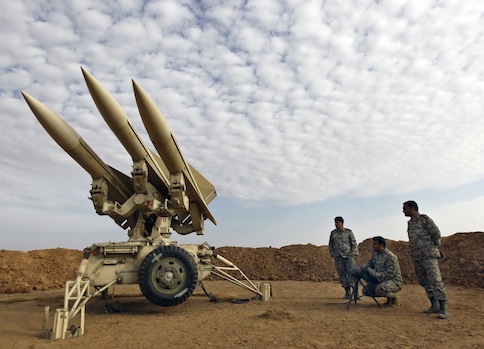 Iranian army members prepare missiles to be launched / AP