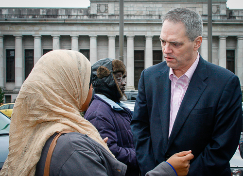 Ross discusses refugee issues with a young woman who moved here from Minnesota