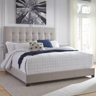 Modern inspired design with nicely crafted crystal button tufting accents on headboard, this bed. signature design by ashley dolante collection tufted bed