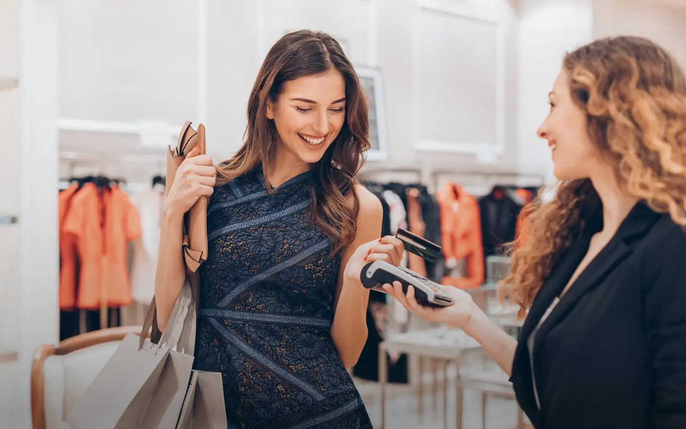 Happy customer using a POS device for seamless retail payment processing.