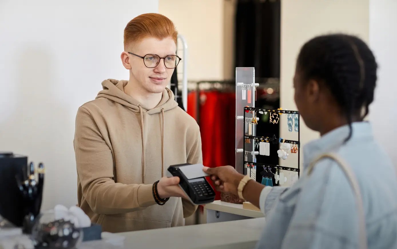 Retail associate assisting a customer with in-store retail payment processing.