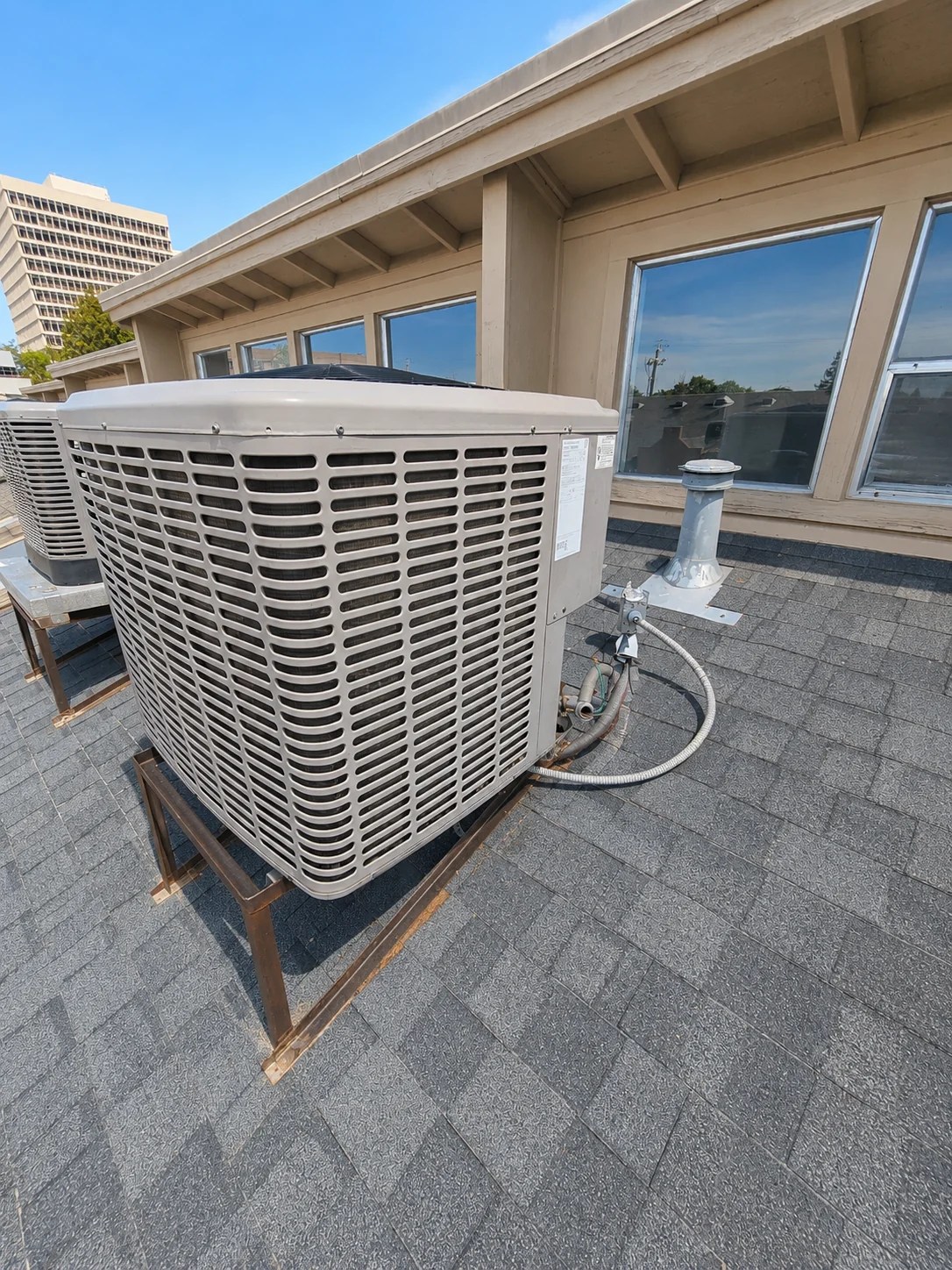 Rooftop air conditioning condenser installed outside a residential building