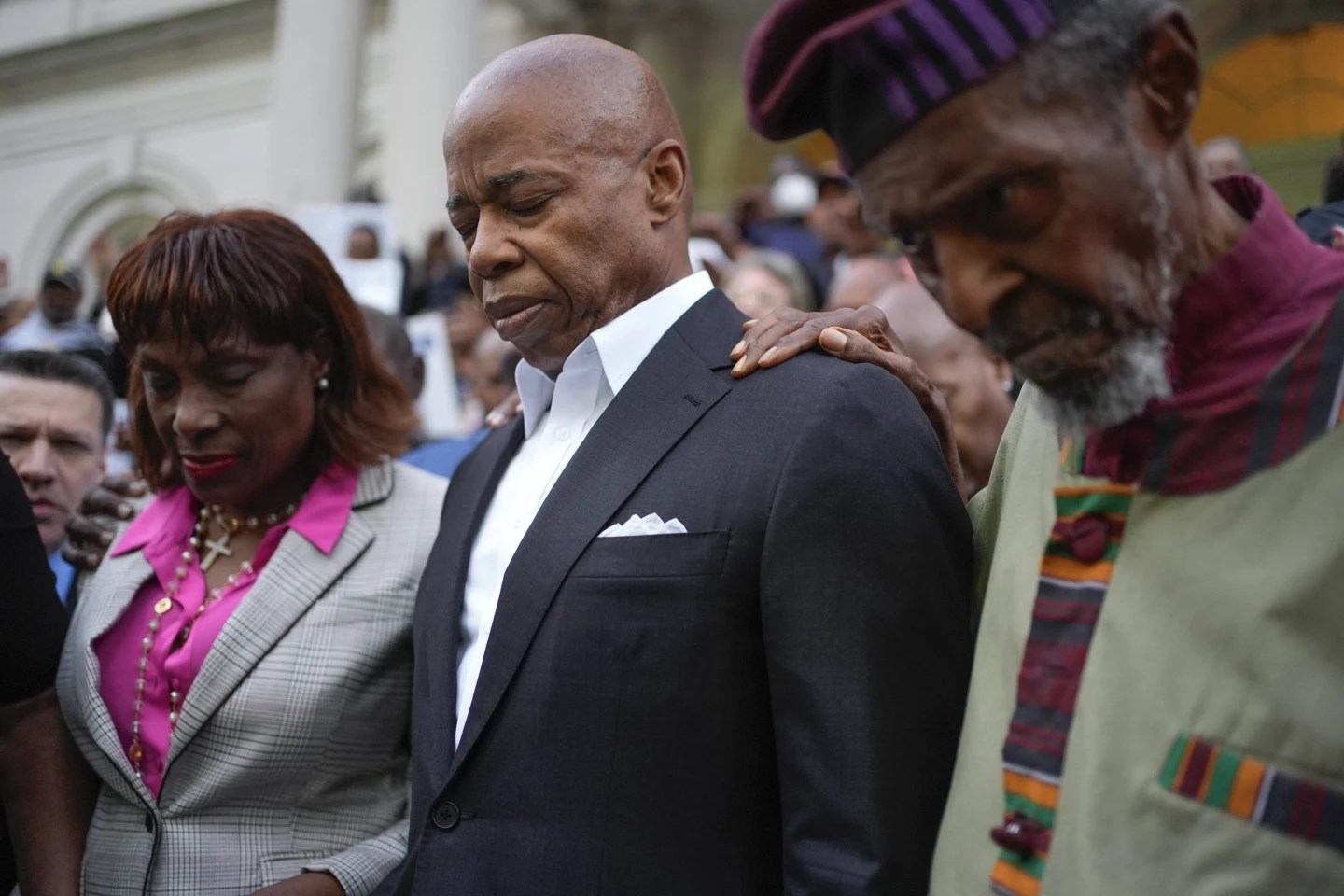Faith leaders and other supporters pray over New York City Mayor Eric Adams, center, during a rally and prayer vigil on the steps of City Hall in New York, Oct. 1, 2024. (AP Photo/Seth Wenig)