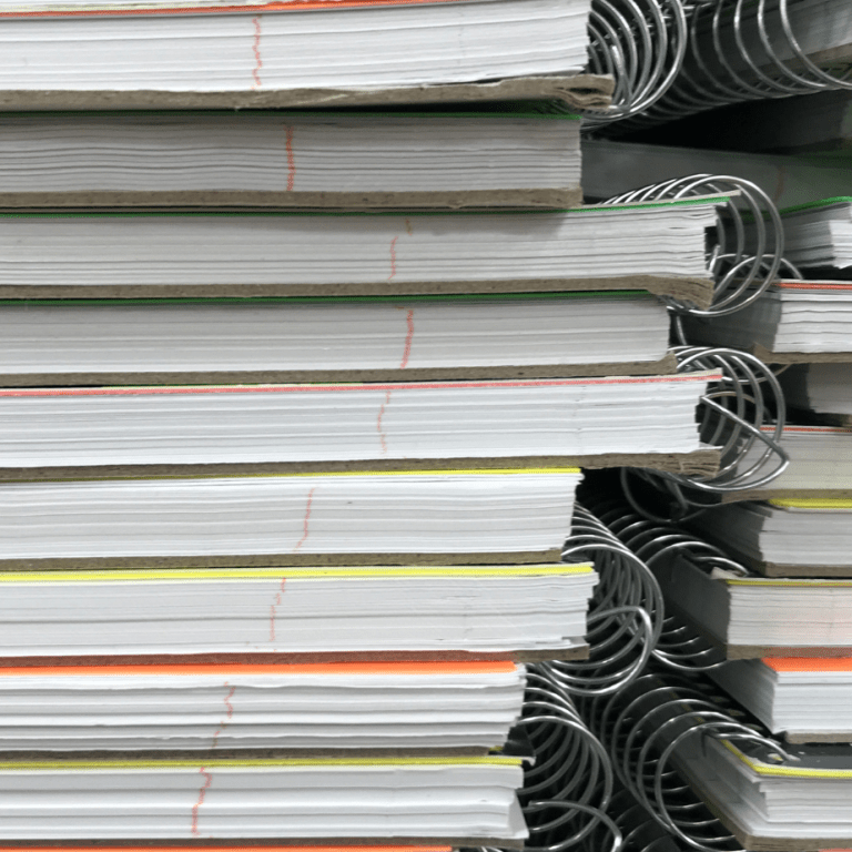 two stacks of spiral notebooks