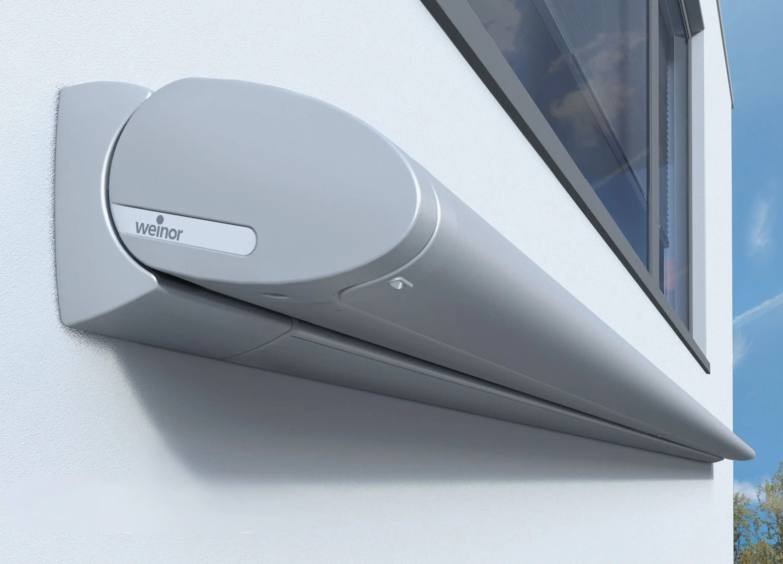 dual green cassette awnings installed above patio doors on brick house