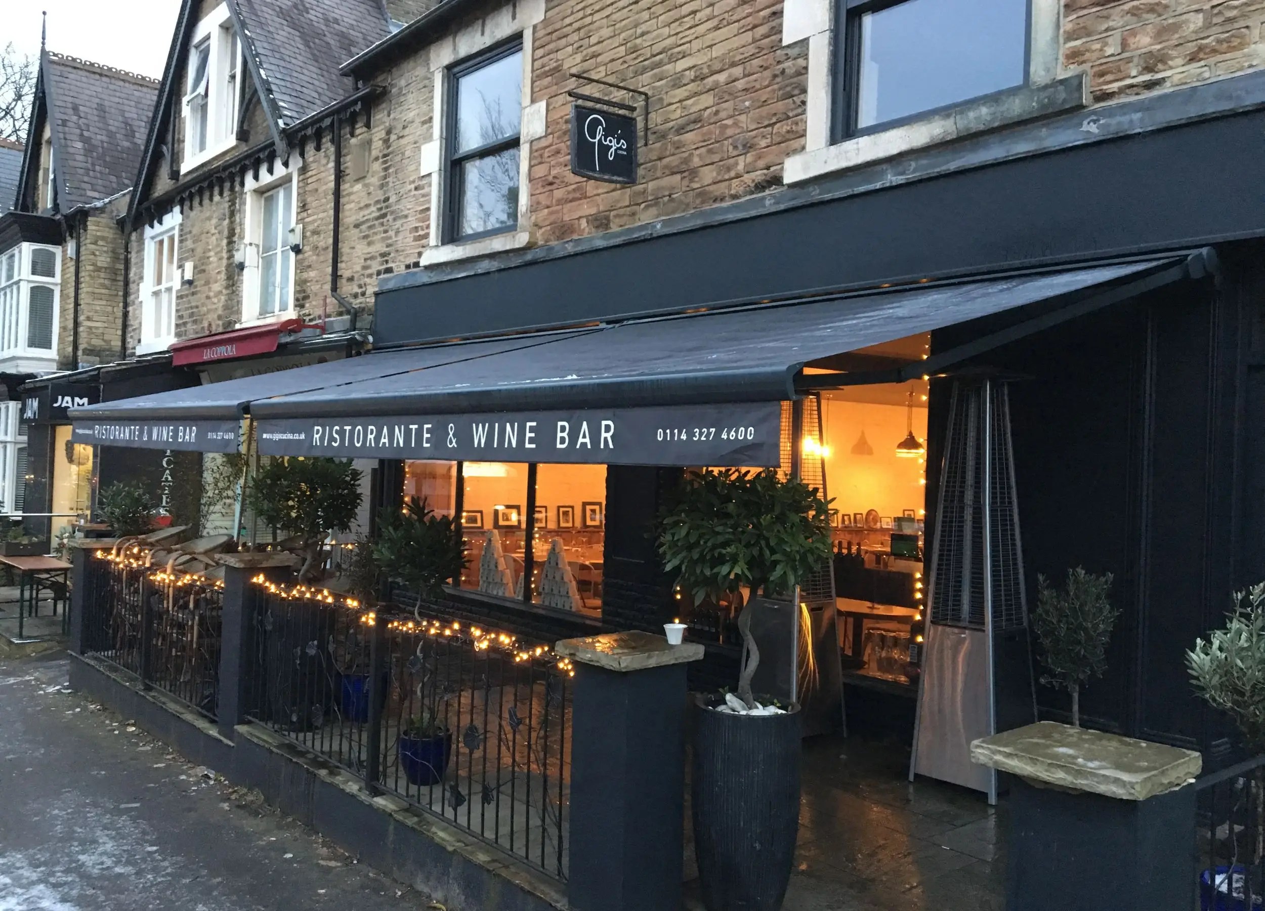 Bartlow awnings installed at ristorante and wine bar exterior with branding.