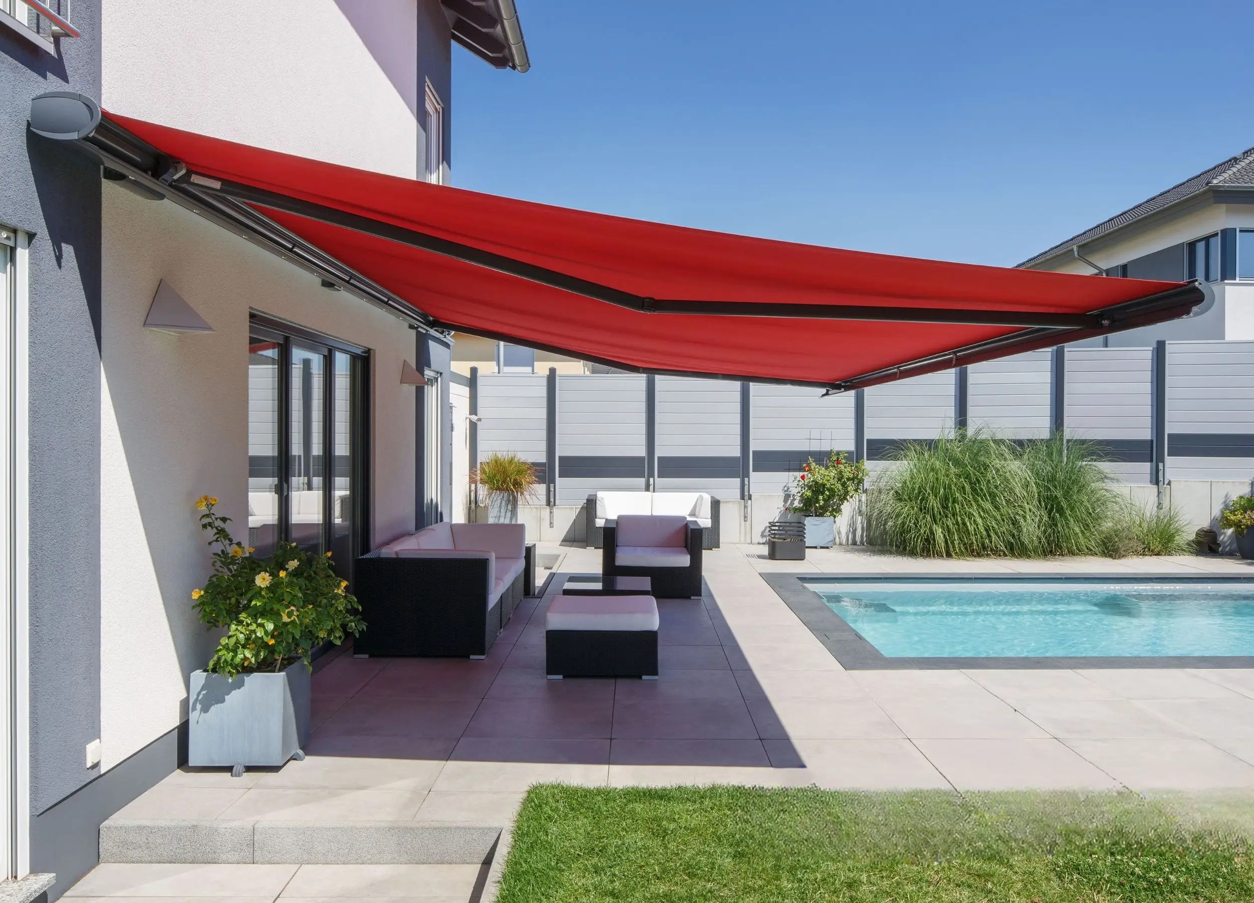 This premium Weinor awning offers seamless sun protection for outdoor lounging areas, blending effortlessly into the architectural design of this luxury property. Ideal for enhancing comfort by the poolside while protecting from UV rays.